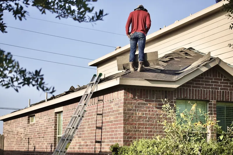 Professional roofer working on a residential roof in Summerville Place